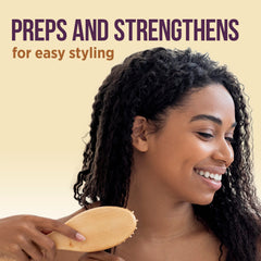 Applying Pantene Gold Series detangling milk to damp hair, reduces tugging while combing