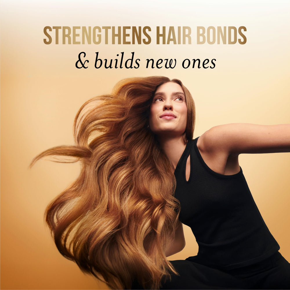 Pantene applied to damp hair in hand demonstrating quick absorption and detangling