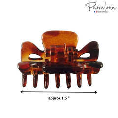 Parcelona beside a hand for size comparison, shows compact 1.5 inch scale benefit