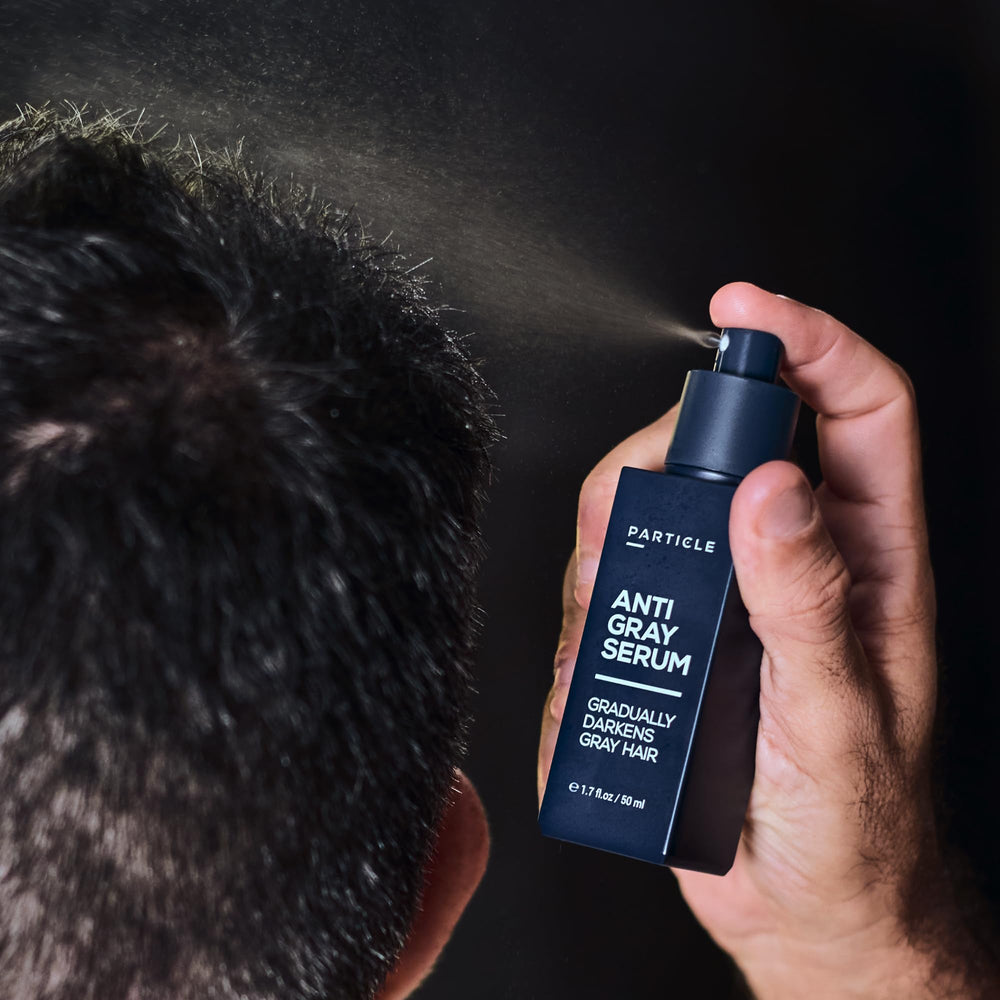 Particle serum next to common toiletry items indicating size and travel-friendly design