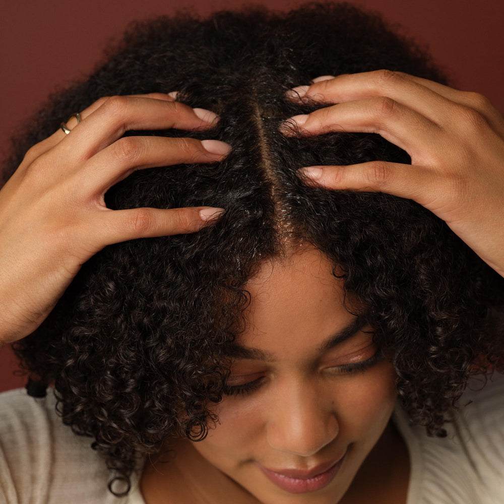 PATTERN product applied to a parted hair section for precise cleanse