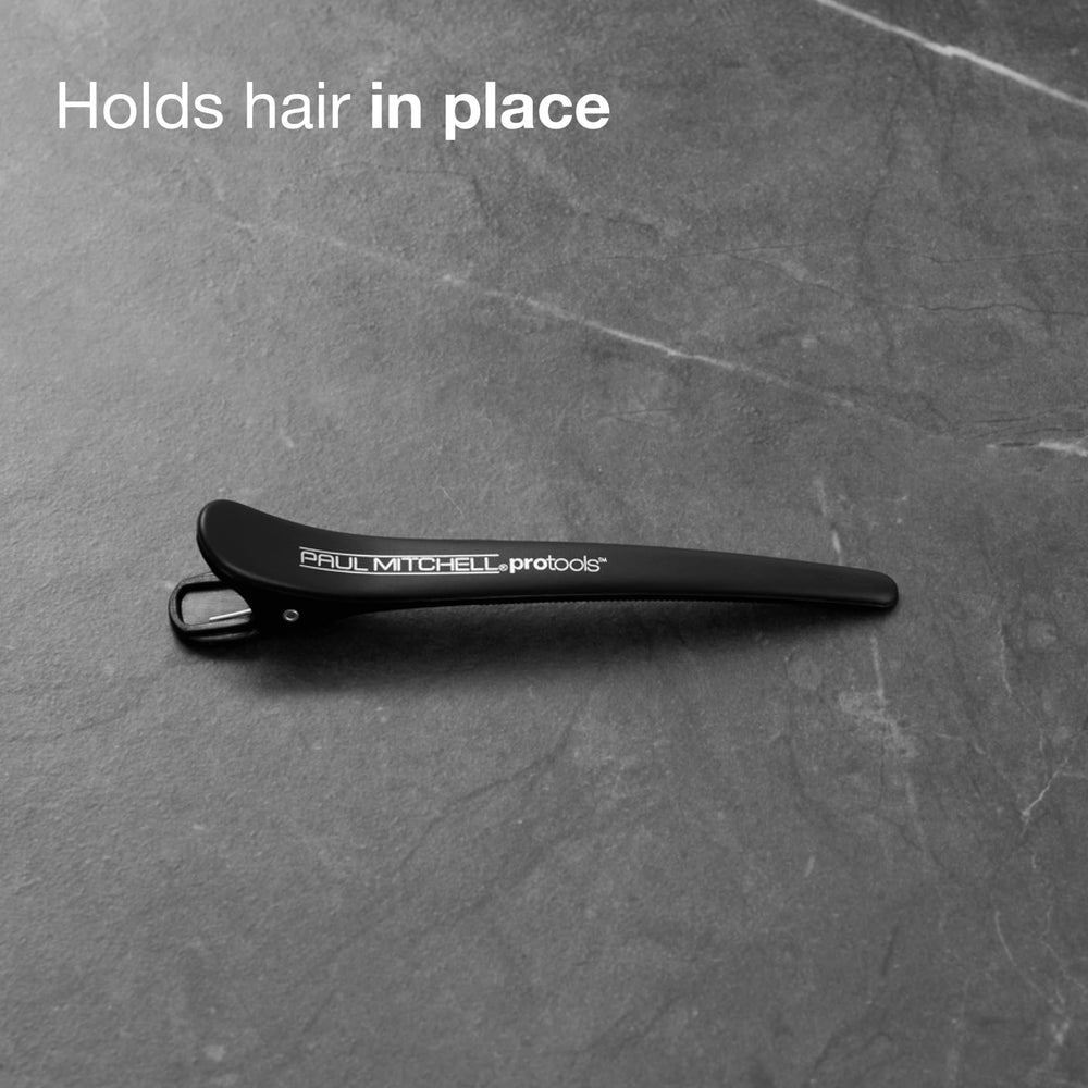 Paul Mitchell clips holding hair during blowout demonstrating no-crease styling benefit