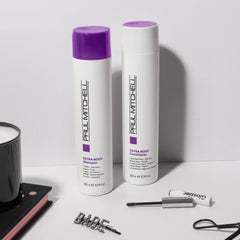 Paul Mitchell travel-size beside full bottle showing portable convenience