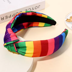 PHALIN headband worn by model outdoors adding festive Pride color and confidence