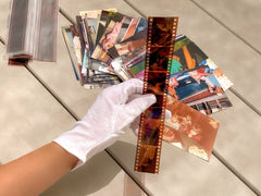 PHOTOMYNE gloves in use handling a vintage photograph to prevent smudges