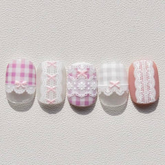 Phuryllic on bridal manicure showing delicate white bows for weddings