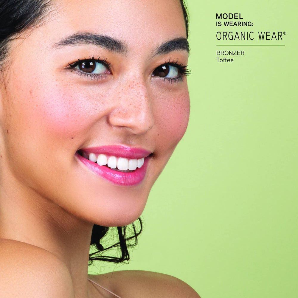 Physicians Formula bronzer stick being applied to cheek for natural sculpting