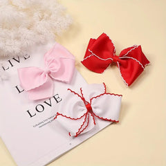 pipajoy rainbow and heart bows arranged to show color coordination and outfit matching