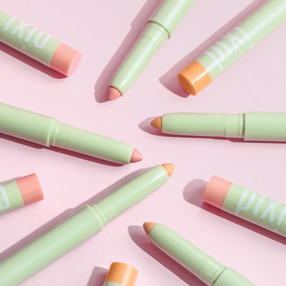 Pixi crayon next to a coin for scale, travel-friendly compact size benefit