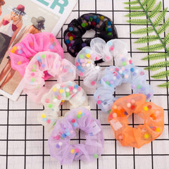 POZILAN scrunchie next to a hand showing compact size and comfortable fit