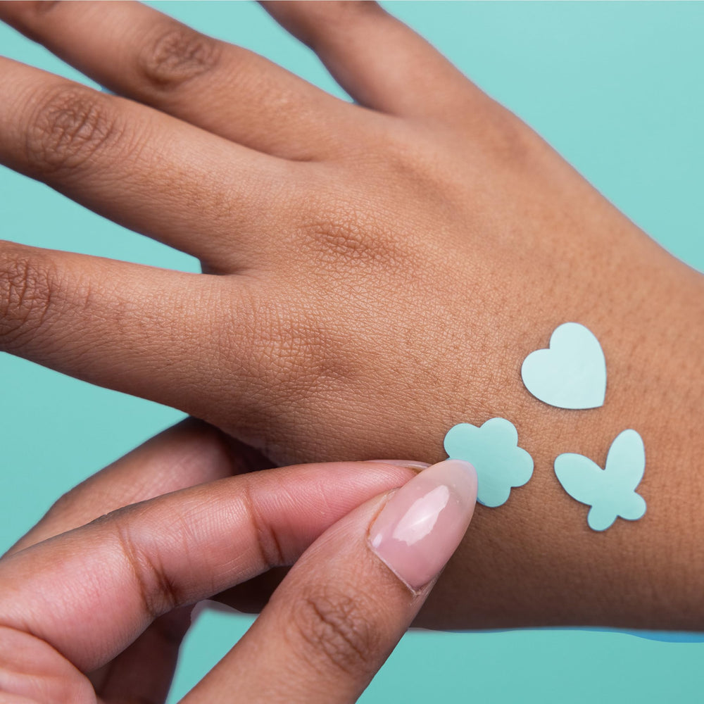 Proactiv patch next to fingertip showing scale for accurate sizing and targeted coverage benefit