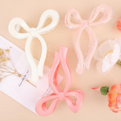 PWEOUKE front view bow clip showing shape and glossy finish for polished looks