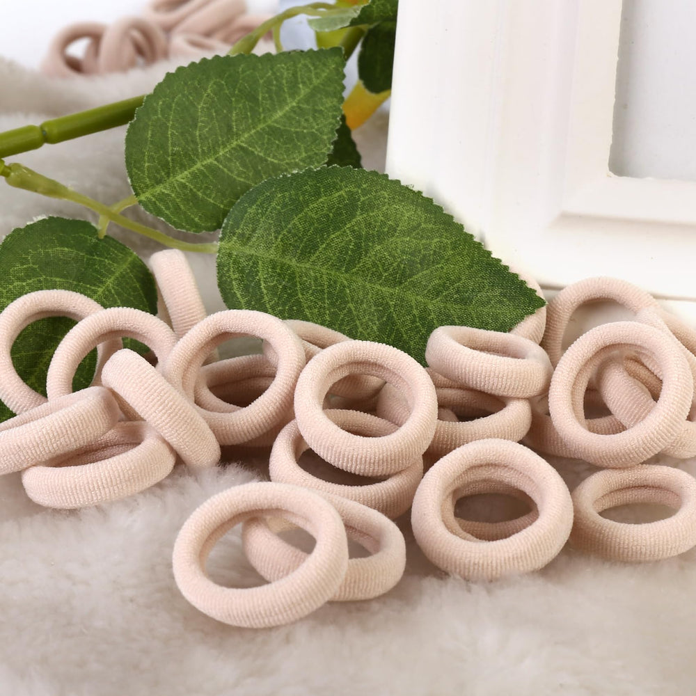 qarwayoc baby wearing pigtails secured with blonde mini hair ties for comfort