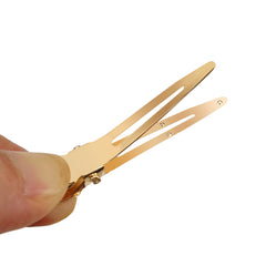 Qearl single-prong clip holding a pin curl, keeps style secure