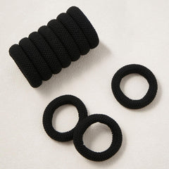 QIUTIMIY hair tie beside a hand to show size and stretchability for multiple wraps