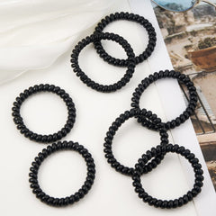 QIUTIMIY coil beside ruler for size comparison, showing 1.97 inch diameter clarity
