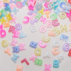 Quezadyl tweezers placing a resin letter showing precise application and professional finish benefit