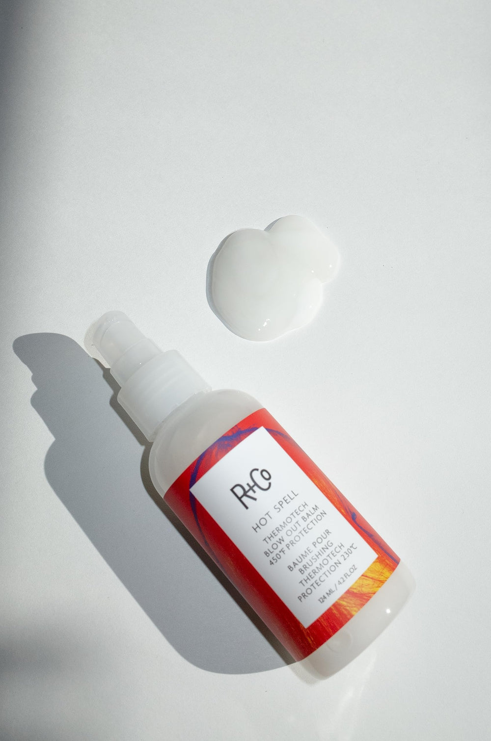 R+Co Hot Spell creamy balm texture transforming to smooth cream for easy styling