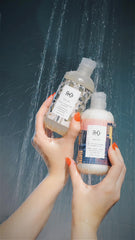 R+Co Dallas bottle beside hand for scale showing travel-friendly size and salon quality