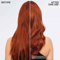 Redken conditioner on hair strand held in hand showing softer feel
