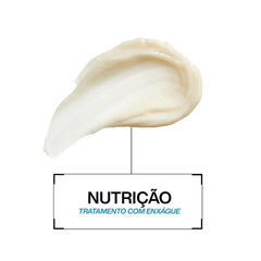 Redken product label close-up showing key ingredients like biotin and niacinamide