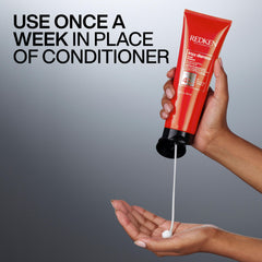 Redken Frizz Dismiss mask cream on hands demonstrating slip and easy application benefit