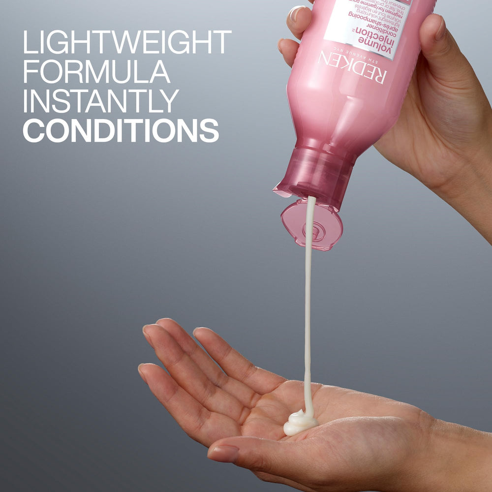 Redken bottle beside ruler showing 33.8 fl oz scale and value