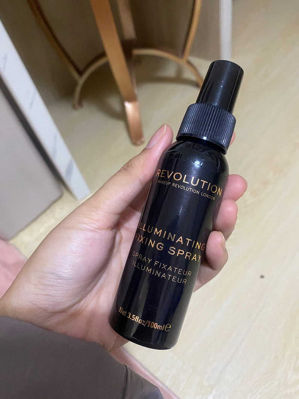 Revolution Beauty London spray in use on model demonstrating sweat-resistant makeup benefit