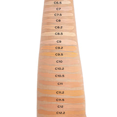 Person applying Revolution concealer C8 under eye for brightening effect