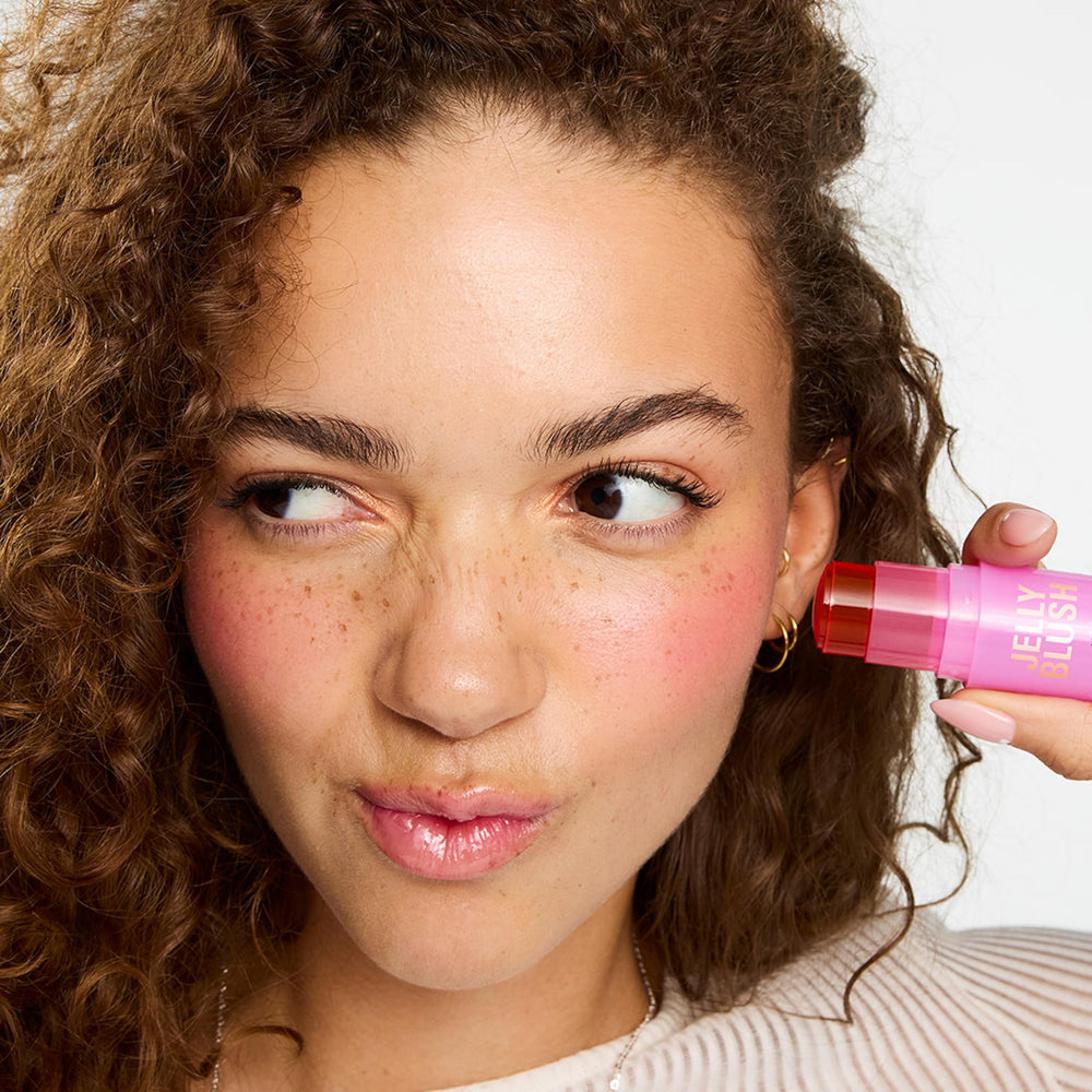 Revolution Jelly Blush Stick on lips closeup highlighting hydrated, buildable color
