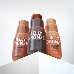 Revolution bronzer held in hand to show size and travel-friendly convenience benefit