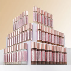 Revolution Beauty London applying foundation in mirror for natural finish