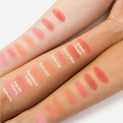 Revolution Beauty London swatch on skin showing warm coral payoff and buildability