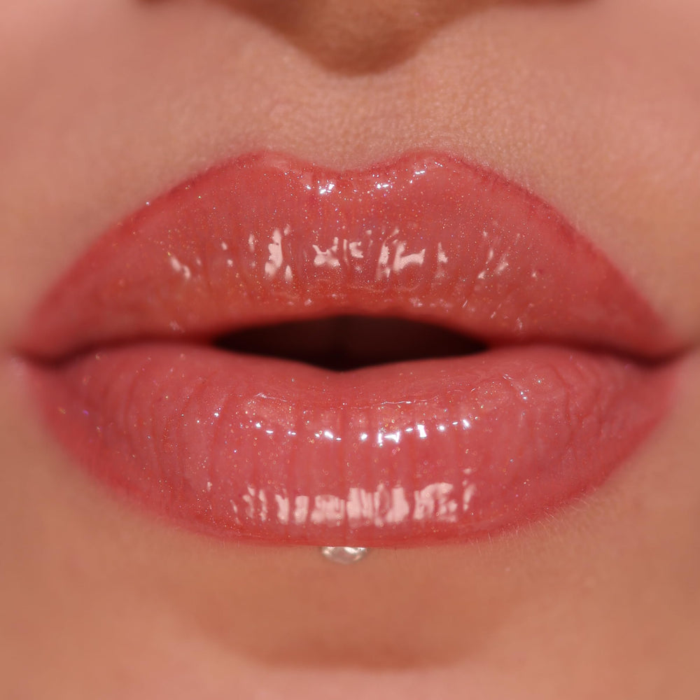 Revolution Skincare London gloss texture swatch on hand showing shimmer and hydrating finish benefit