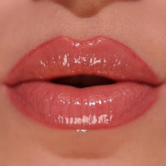 Revolution Skincare London gloss texture swatch on hand showing shimmer and hydrating finish benefit
