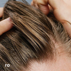 Man using Ro shampoo in shower illustrating refreshed scalp benefit