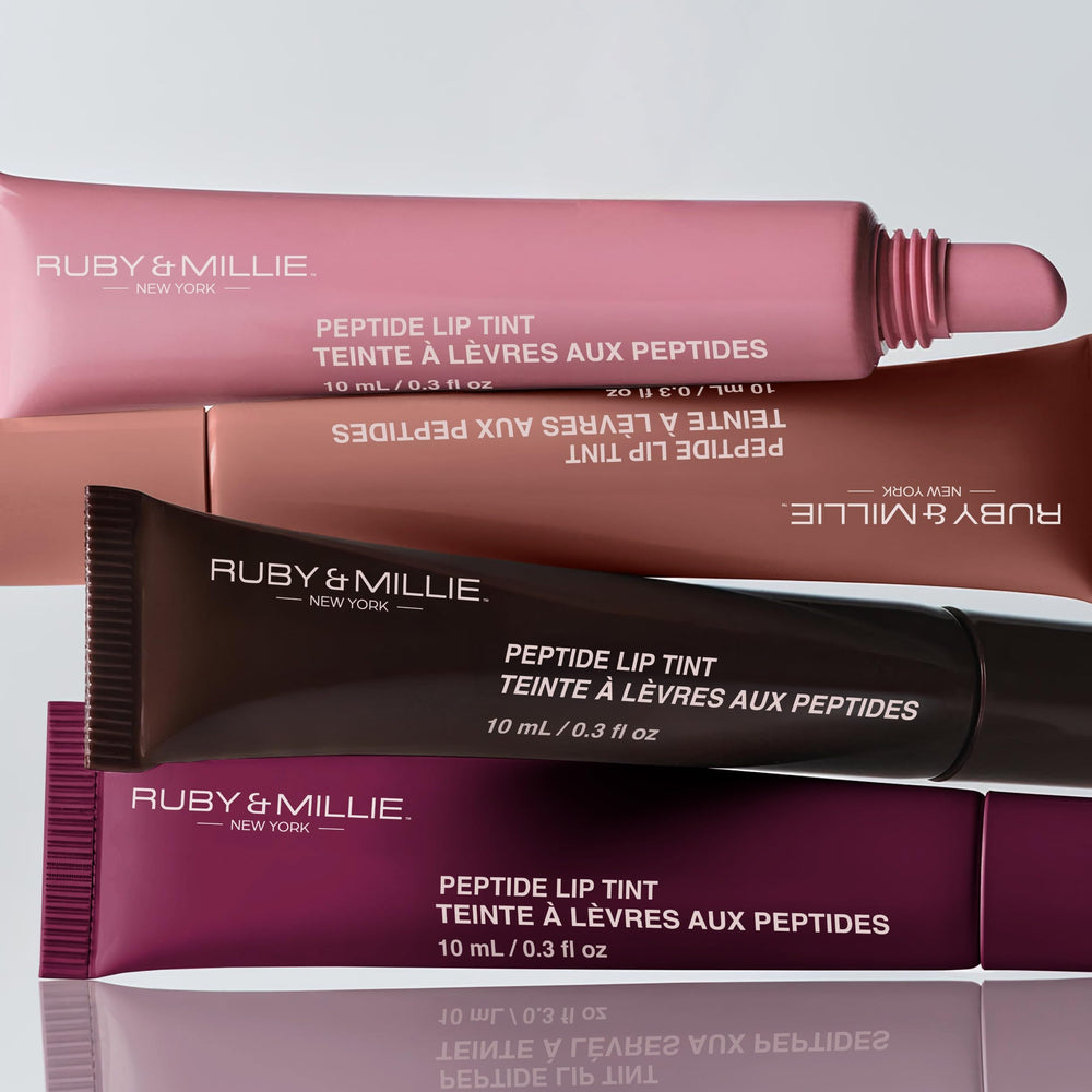 Ruby & Millie size comparison next to coin showing compact 0.3 fl oz tube
