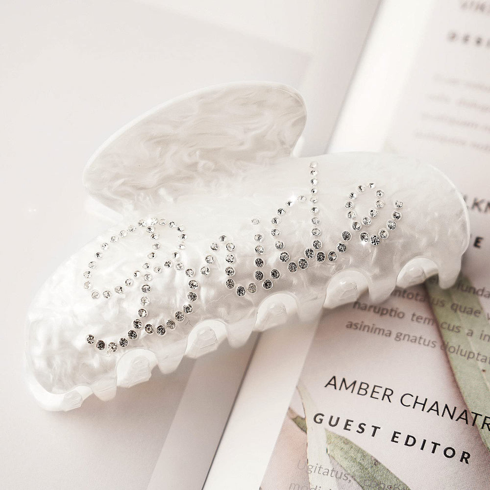 Saliyaa bride clip logo closeup highlighting double-sided lettering detail