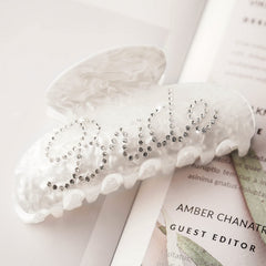 Saliyaa bride clip logo closeup highlighting double-sided lettering detail
