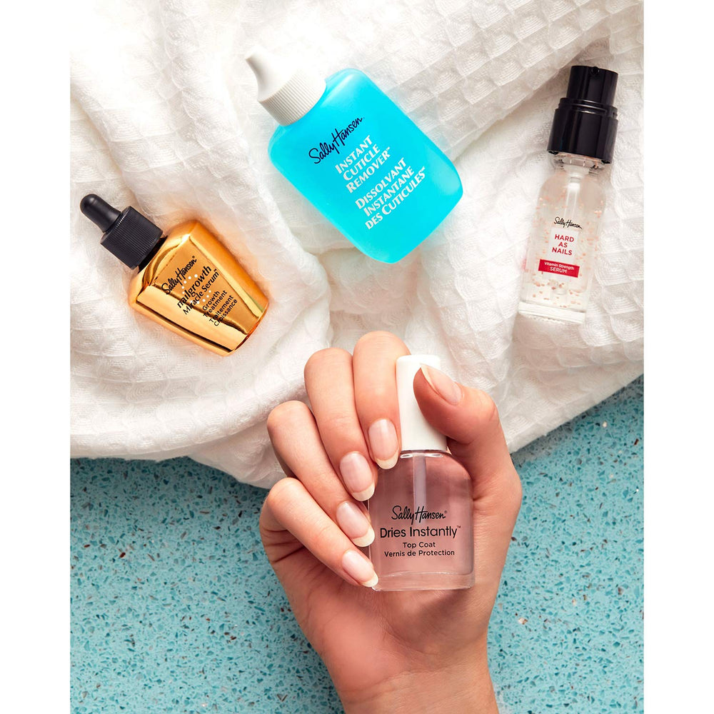 Sally Hansen lifestyle hand applying serum showing stronger-looking nails