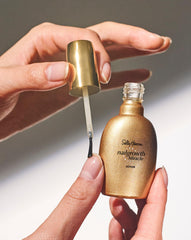 Sally Hansen bottle beside coin shows compact 0.45 fl oz travel-friendly size