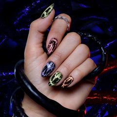 Sally Hansen Squawk glow-in-the-dark nails lit in low light for dramatic effect