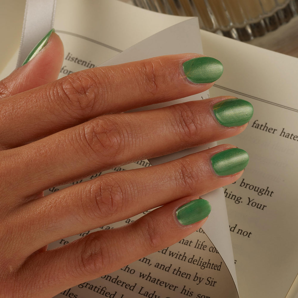 Sally Hansen holiday manicure on hands conveying festive, long-lasting shine