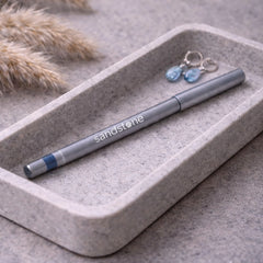Sandstone Scandinavia pencil held next to hand showing true size and control