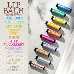 Lifestyle outdoor scene with Savannah Bee Company lip balm protecting lips in wind