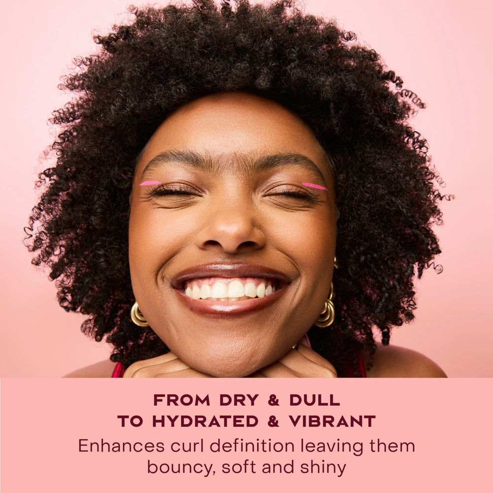 SheaMoisture being applied to damp hair in sections demonstrating controlled styling and frizz reduction