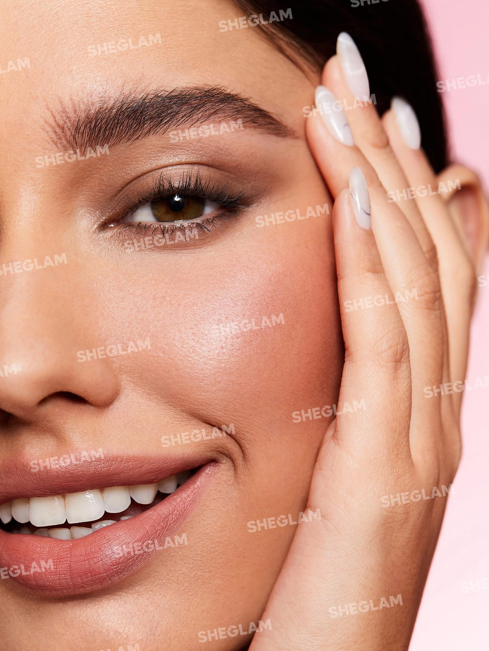 SHEGLAM pencil held in hand illustrating compact travel-friendly size