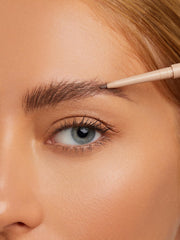 SHEGLAM pencil held in hand indicating compact travel-friendly size