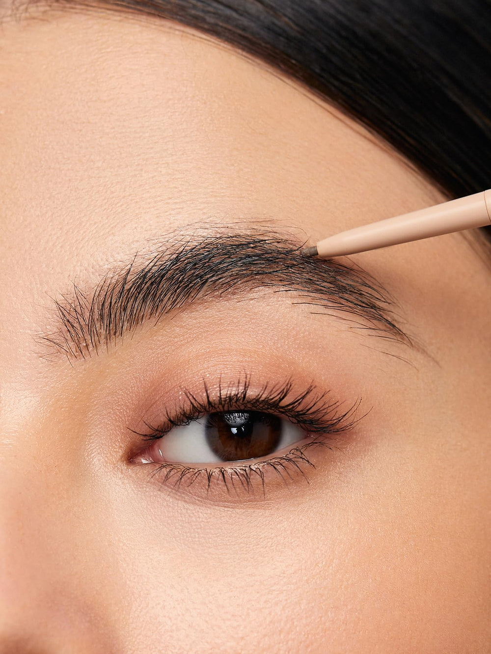 SHEGLAM pencil held in hand to show size and easy control benefit