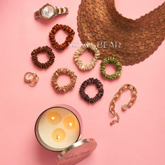 silvr bear scrunchie next to coin for size comparison showing compact profile